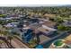 Expansive aerial view of a suburban neighborhood with mature trees and a golf course nearby at 1057 S 74Th St, Mesa, AZ 85208