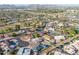 High-angle aerial view shows a well-planned neighborhood with houses and green spaces at 1057 S 74Th St, Mesa, AZ 85208
