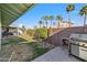 Spacious backyard with mature landscaping, grill, and well-maintained lawn, perfect for outdoor entertaining at 1057 S 74Th St, Mesa, AZ 85208
