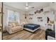 Well-lit room features wood-look tile flooring, ceiling fan and a relaxing sitting area at 1057 S 74Th St, Mesa, AZ 85208