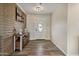 Welcoming home entryway features wood-look tile flooring, decorative console table, and a bright white door at 1057 S 74Th St, Mesa, AZ 85208