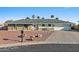 Charming single-story home featuring desert landscaping, a gray roof, and a two-car garage at 1057 S 74Th St, Mesa, AZ 85208