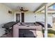 Hot tub on the covered patio with ceiling fan, surrounded by brick, offering a private relaxation space at 1057 S 74Th St, Mesa, AZ 85208