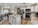 Open-concept kitchen with granite countertops and stainless steel appliances, seamlessly connected to dining area at 1057 S 74Th St, Mesa, AZ 85208