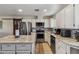 Bright kitchen featuring white cabinets, granite countertops, stainless steel appliances, and ample counter space at 1057 S 74Th St, Mesa, AZ 85208