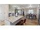Bright kitchen island with bar seating, granite countertops, and modern finishes at 1057 S 74Th St, Mesa, AZ 85208
