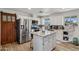 Bright kitchen featuring white cabinets, granite countertops, stainless steel appliances, and an island at 1057 S 74Th St, Mesa, AZ 85208