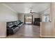 Large living room featuring tile flooring, a comfortable leather sofa, and sliding glass doors leading to the patio at 1057 S 74Th St, Mesa, AZ 85208