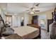 Large bedroom features tile flooring, door to the pool area, and an ensuite bathroom at 1057 S 74Th St, Mesa, AZ 85208