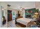 Cozy main bedroom featuring a decorative fireplace, ceiling fan, and outside access at 1057 S 74Th St, Mesa, AZ 85208