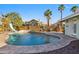 Beautiful backyard pool with a slide, seating area, and mature landscaping, perfect for outdoor relaxation at 1057 S 74Th St, Mesa, AZ 85208