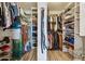 Spacious walk-in closet with custom shelving and wood-look tile flooring at 1057 S 74Th St, Mesa, AZ 85208