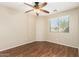 Comfortable bedroom featuring hardwood floors, ceiling fan, and a window at 1138 E Avenida Isabela St, Casa Grande, AZ 85122