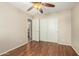 Bright bedroom with wood floors, fan, closet, and bathroom view at 1138 E Avenida Isabela St, Casa Grande, AZ 85122