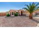 Single-story home with desert landscaping and a lovely palm tree, featuring large bay windows at 1138 E Avenida Isabela St, Casa Grande, AZ 85122