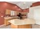 Bright kitchen featuring tile flooring, stainless steel appliances, and island at 1138 E Avenida Isabela St, Casa Grande, AZ 85122