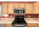 The kitchen area showcases stainless steel appliances and wooden cabinets at 1138 E Avenida Isabela St, Casa Grande, AZ 85122