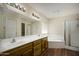 Bright bathroom featuring a double vanity, soaking tub, and separate glass-enclosed shower at 11447 E Mendoza Ave, Mesa, AZ 85209