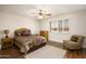 Comfortable bedroom with a ceiling fan, window shutters, and neutral decor at 11447 E Mendoza Ave, Mesa, AZ 85209