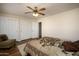 This bedroom has a ceiling fan and double closets, perfect for storage at 11447 E Mendoza Ave, Mesa, AZ 85209