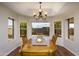 Bright dining room with hardwood floors, chandelier and great views of the backyard at 11447 E Mendoza Ave, Mesa, AZ 85209