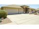 Charming home featuring a three-car garage and desert landscaping for low maintenance appeal at 11447 E Mendoza Ave, Mesa, AZ 85209