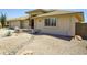 Home exterior showcasing desert landscaping, rock features and a wall detail in the yard at 11447 E Mendoza Ave, Mesa, AZ 85209