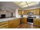 Open kitchen boasts granite countertops, stainless steel appliances, and ample cabinet space at 11447 E Mendoza Ave, Mesa, AZ 85209