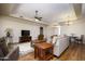 A spacious living room featuring hardwood floors, a ceiling fan, and ample furniture at 11447 E Mendoza Ave, Mesa, AZ 85209