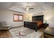 Cozy main bedroom with hardwood flooring, tray ceiling, and large decorative furnishings at 11447 E Mendoza Ave, Mesa, AZ 85209