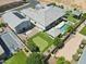 Aerial view of the backyard oasis featuring a pool, spa, cabana, putting green, and a basketball court at 1160 E Cedar Pl, Chandler, AZ 85249