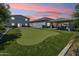 Entertainer's dream backyard featuring a putting green, covered patio, and beautifully landscaped grounds for outdoor enjoyment at 1160 E Cedar Pl, Chandler, AZ 85249