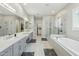 This primary bathroom features grey cabinets, a large tub, walk in shower, and tile flooring at 1160 E Cedar Pl, Chandler, AZ 85249