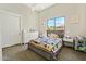 Cozy bedroom with a large window, a colorful quilt, and a white dresser at 1160 E Cedar Pl, Chandler, AZ 85249