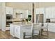 Bright kitchen featuring a kitchen island with white cabinets and modern appliances at 1160 E Cedar Pl, Chandler, AZ 85249