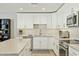 Modern kitchen featuring white cabinets, stainless steel appliances, and a center island at 1160 E Cedar Pl, Chandler, AZ 85249