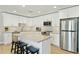 Bright kitchen with stainless steel appliances, an island with barstool seating, and white cabinetry at 1160 E Cedar Pl, Chandler, AZ 85249