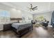 Spacious main bedroom features a dark wood sleigh bed, sitting area, wood floors, and abundant natural light at 1160 E Cedar Pl, Chandler, AZ 85249