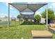 A backyard play structure provides fun and exercise with a jungle gym, swings, and a trampoline in a green space at 1160 E Cedar Pl, Chandler, AZ 85249