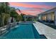 Luxurious pool and spa featuring a cascading waterfall and an outdoor cabana, perfect for relaxation and entertainment at 1160 E Cedar Pl, Chandler, AZ 85249