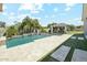 Stunning backyard oasis featuring a sparkling swimming pool, lush landscaping, and a covered outdoor dining area for entertainment at 1160 E Cedar Pl, Chandler, AZ 85249
