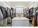 Large walk-in closet with central island, extensive shelving, and custom storage solutions at 1160 E Cedar Pl, Chandler, AZ 85249