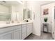 Well-lit bathroom featuring a double vanity, framed mirrors, stylish fixtures and a separate shower stall at 14870 W Encanto Blvd # 2138, Goodyear, AZ 85395