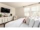 Inviting bedroom with a dresser, sitting chair, and sheer curtains at 14870 W Encanto Blvd # 2138, Goodyear, AZ 85395