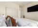 Comfortable bedroom featuring a flat-screen TV and sliding closet doors at 14870 W Encanto Blvd # 2138, Goodyear, AZ 85395