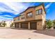 Townhome featuring garages, neutral tones, and a brick driveway at 14870 W Encanto Blvd # 2138, Goodyear, AZ 85395