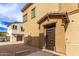 The front entrance features a modern brown door and a well-kept walkway with tan exterior at 14870 W Encanto Blvd # 2138, Goodyear, AZ 85395