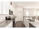 Bright kitchen features white cabinets, granite countertops, stainless appliances, and a functional island with seating at 14870 W Encanto Blvd # 2138, Goodyear, AZ 85395
