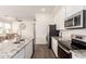 Bright kitchen features white cabinets, granite countertops, stainless appliances, an island and opens to the living space at 14870 W Encanto Blvd # 2138, Goodyear, AZ 85395
