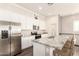 Bright kitchen features white cabinets, granite countertops, stainless appliances and an island with bar stool seating at 14870 W Encanto Blvd # 2138, Goodyear, AZ 85395
